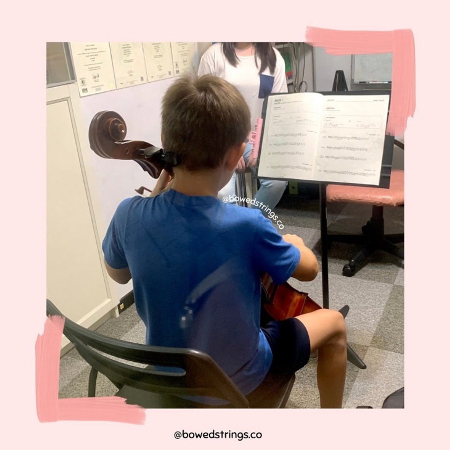 A young student in a cello lesson at the studio