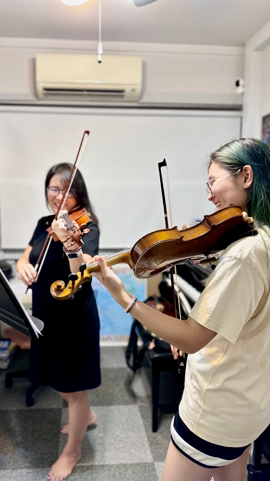 Two violinists playing together during a studio lesson