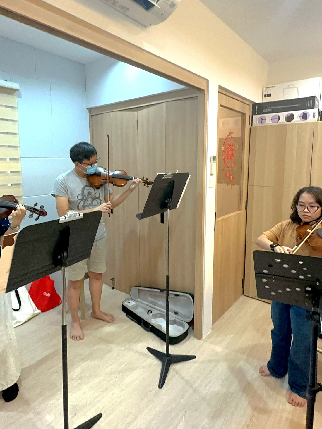 Adult students playing violin together in a group class
