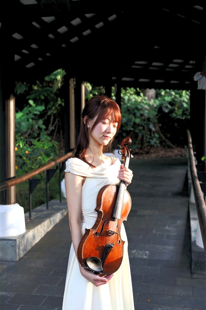 A Bowed Strings violin instructor holding her violin